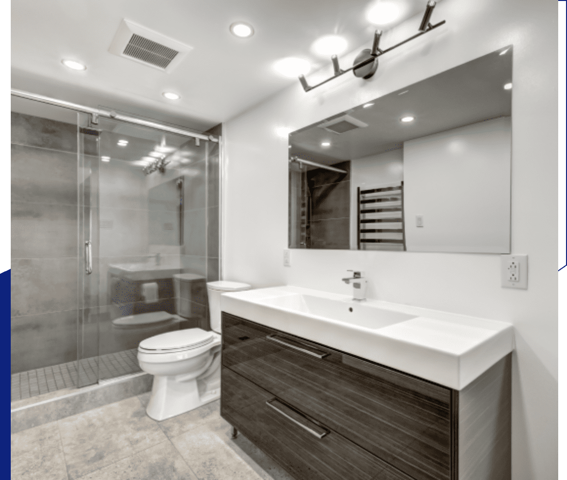 Modern bathroom with large mirror, sleek vanity, and metallic fixtures.